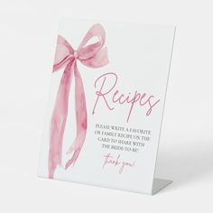 a card with a pink ribbon on it that says, recipes please write a favorite recipe on the card