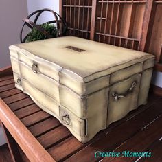 an old trunk sitting on top of a wooden table