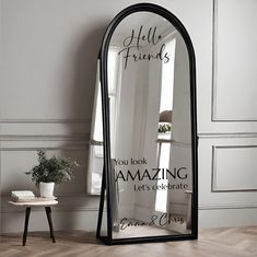 a mirror with the words hello friends on it in front of a table and chair