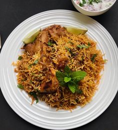 a white plate topped with chicken and rice