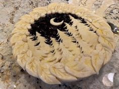 a pie sitting on top of a counter covered in icing