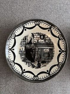 a black and white plate with an image of a man in the fireplace on it