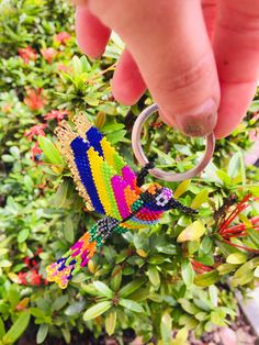 someone is holding onto a keychain made out of beads