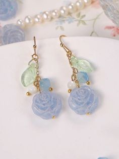 Elevate your style with these exquisite Icy Blue Rose Czech Glass Beads Dangling Drop Earrings. Handcrafted with precision and care, these earrings are a true embodiment of elegance and romance. The focal point of these handmade earrings is the stunning icy blue rose Czech glass beads. Each bead captures the delicate beauty of a rose in full bloom, with intricate details and a mesmerizing blue hue that adds a touch of enchantment. The beads are carefully arranged in a dangling drop design, creat Blue Rose Earrings, Blue Flower-shaped Resin Earrings, Rose Romantic, Meaningful Gifts For Her, Romantic Earrings, Diy Jewelry Inspiration, Rose Bleu, Drop Design, Delicate Beauty