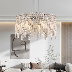 a living room filled with furniture and a crystal chandelier hanging from the ceiling