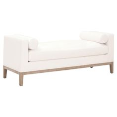 a white couch sitting on top of a wooden frame