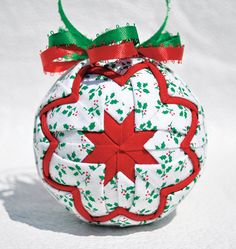 a christmas ornament hanging from a green ribbon