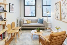 a living room filled with furniture next to a window covered in lots of bookshelves