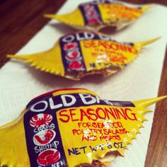 three old bay seasoning packets sitting on top of a table next to each other