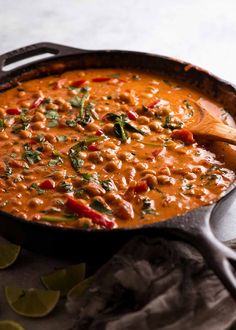 a skillet filled with red curry and vegetables