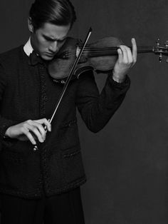 a man is playing the violin in black and white