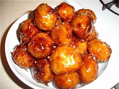 a white plate topped with fried food on top of a counter next to a stove