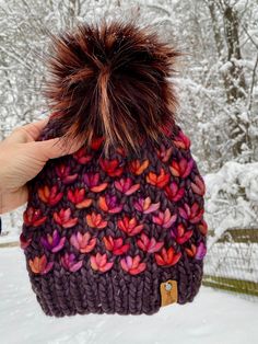 "This gorgeous hat is hand knit with ❤️ by me using ethically sourced pure merino wool from Malabrigo.  This high quality merino wool is luxuriously soft, warm, breathable and not itchy. It is suitable even for sensitive people who can't tolerate regular wool. Wool hats will keep you warm without overheating or sweating. Malabrigo wool is hand dyed in small batches making every hat unique. Care: Remove faux fur pom pom before washing simply by untying it from the button on the inside of hat. Hand wash with cool water and gentle wool safe detergent. Lay flat to dry. Pom pom is spot clean only. Size: Women One Size. Will fit most adult heads (19 - 23\" circumference). Hat will be a little slouchy on smaller heads and more fitted on larger sized heads. Free shipping within continental United Flower Beanie, Wool Hats, Sensitive People, Faux Fur Pom Pom, Fur Pom Pom, Lovely Things, Wool Hat, Small Batches, Knit Beanie