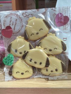 some cookies in the shape of animals on a table next to a package of hearts