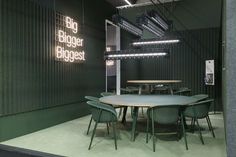 a table and chairs in front of a sign that says big bigger biggest