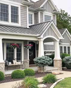 a house with gray shingles and white trim