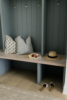 a hat and some shoes are sitting on a bench in a room with blue walls