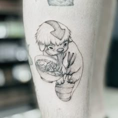 a person with a tattoo on their leg eating food