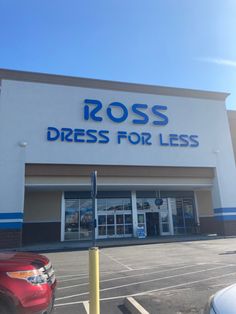 a dress for less store front with cars parked in the lot and on the sidewalk