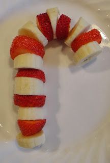 strawberries and bananas arranged in the shape of a candy cane