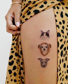 a woman's thigh with two dogs and a cat on it