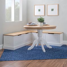 a white table with two open boxes on it and a blue rug in the corner