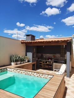 an outdoor swimming pool with patio furniture and potted plants on the roof top terrace