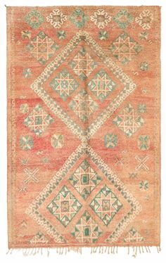 an orange and green rug with geometric designs