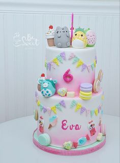 a three tiered cake decorated with animals and decorations