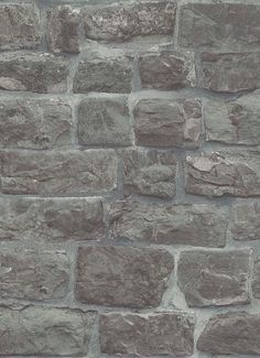 a brick wall made out of grey stones