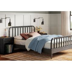 a metal bed frame in a bedroom with white walls