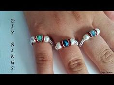 three rings with different colored stones and pearls on each one ring is made from sterling silver