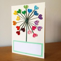 a card that has been made to look like a flower with paper hearts on it