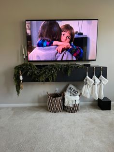 Christmas, christmas garland, tv stand, garland, greenery, Floating Tv Stand Christmas Decor, Stockings On Floating Shelf, Shelf Garland Christmas, Tv Console Garland Christmas, Garland Tv Stand Christmas, Christmas Console Table Decor Under Tv, Christmas Decorations For Tv Stand, Tv Console Christmas Decor Garland, Floating Mantle Christmas Decor