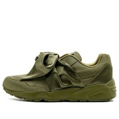 Introducing the newest design from the Fenty x Puma collaboration – the WMNS Bow 'Olive' sneaker. This sporty yet girly sneaker is perfect for ladies who want to be fashionable. The Upper is made of a shimmering textile, while an oversized satin bow on the tongue adds a touch of femininity. Meanwhile, classic Puma stitching and a chunky textured sole provide function and comfort. The result is a sneaker that is both stylish and comfortable – perfect for any active woman. (SNKR/Casual/Women's/But Girly Sneakers, Olive Green Sneakers, Olive Green Shoes, Olive Sneakers, Olive Shoes, Puma Fenty, Puma Trainers, Round Toe Sneakers, Sneakers Puma