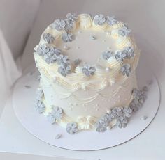 a white frosted cake with flowers on it