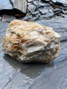 a rock that is sitting on some rocks