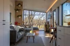 a living room filled with furniture and lots of windows