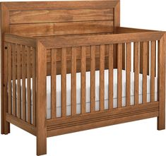 a wooden crib with white sheets on the bottom and side rails, against a white background