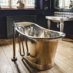 a bath tub sitting on top of a wooden floor