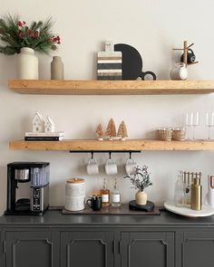 two wooden shelves above a coffee bar with cups and mugs on it's shelf