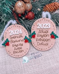 two wooden christmas ornament hanging from a tree