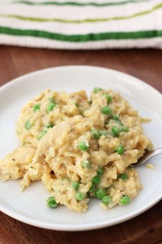 a white plate topped with macaroni and peas