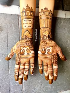 two hands with henna designs on them