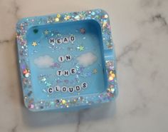 a blue tray with words on it sitting on a marble countertop next to a white wall