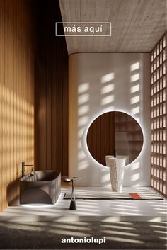 a modern bathroom with wood paneling and round mirror on the wall next to it