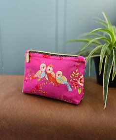 Cute little zippered pouch. Perfect for loose change, credit card and small set of keys. Or holding small items in your bag that would normally roll around the bottom.  The outer fabric is cute birds on a bright pink background. The lining is pale blue. Made from 100% cotton. Closes with a gold coloured zip with a feather zip pull. Height: 12.7cm (5") Width: 15.2cm (6") Depth: 4.5cm (1.75") Pink Pencil Case With Zipper Pocket For Personal Use, Pink Pouch With Zipper Pocket, Pink Pencil Case Pouch With Zipper Pocket, Pink Pouch Pencil Case With Zipper Pocket, Pink Pouch Coin Purse With Zipper, Pink Pencil Case With Zipper Pocket, Pink Zipper Pouch Coin Purse, Pink Zipper Pouch For Everyday Use, Pink Pouch For Everyday Use