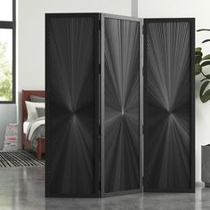 three panel room divider in black and white with an abstract design on the side