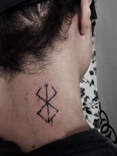 a man with a tattoo on his neck has an arrow in the shape of a cross