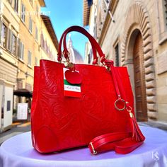 This bag has been made of the best genuine leather by local master crafters of Florence in Italy, designed for women who only accept premium Italian quality and luxury leather bags and modern Italian fashion. . Sizes: Width:   31 cm/12.25 inch Height:  22 cm/8.75 inch Depth:   11 cm/4.25 inch Color: Red . The story of this bag:  In the heart of Florence, where tradition and innovation intertwine, there existed a workshop renowned for its exquisite leather goods. Among the treasures crafted within its walls were leather purses that epitomized elegance and charm, each one a testament to the artisan's skill and dedication. One such creation was a handmade leather bag--a shoulder bag that exuded sophistication and practicality in equal measure. Crafted from the finest Italian leather, it boast Italian Leather Bag As Gift, Italian Leather Bag As A Gift, Red Bag With Leather Lining As Gift, Red Leather Satchel With Handle Drop, Stylish Leather Bags, Handmade Leather Bags, Luxury Leather Bag, Flower Purses, Treasure Crafts